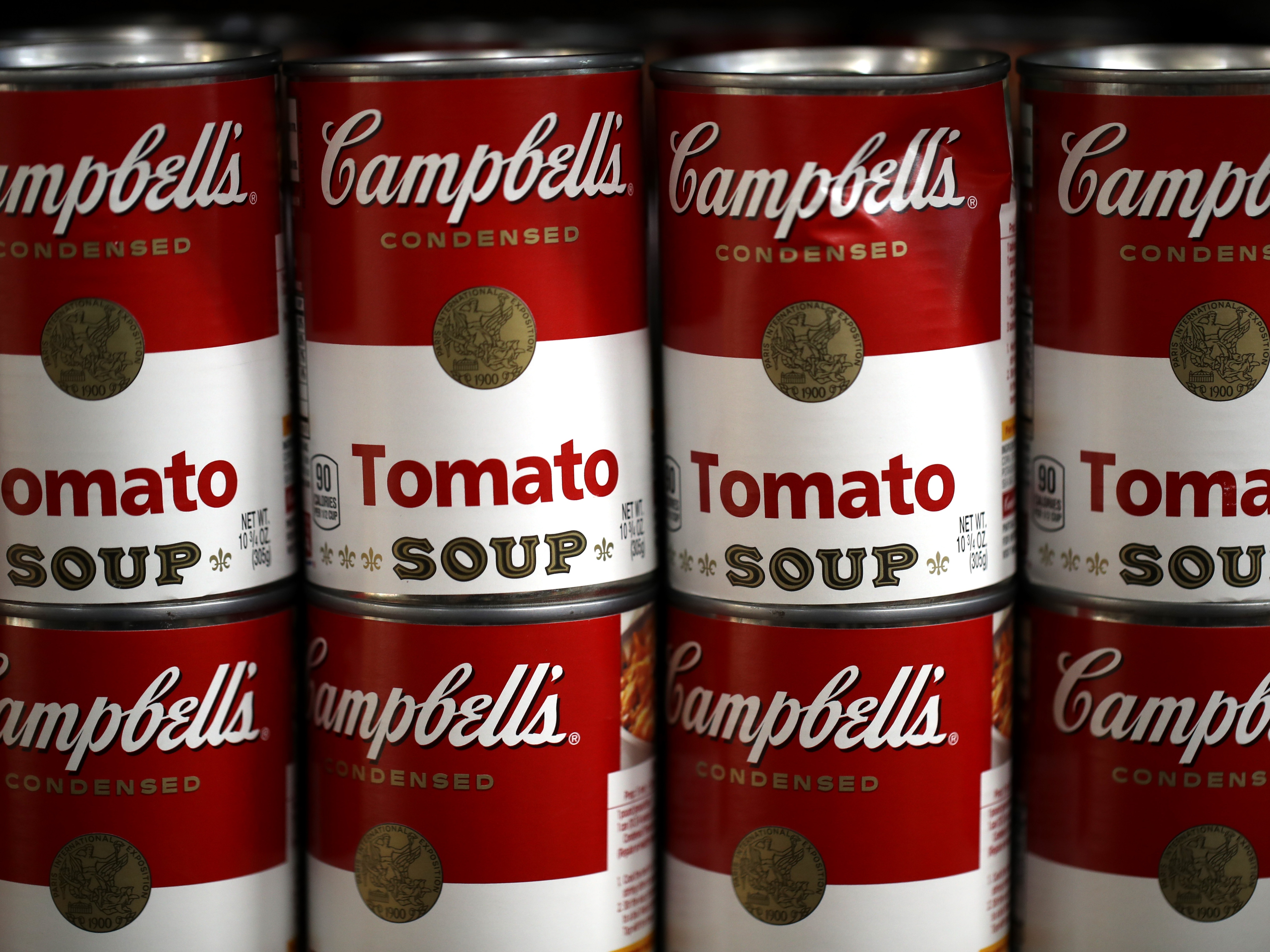 caption: Cans of Campbell's soup are displayed on a shelf at a grocery store in Richmond, Calif., in 2019. The Campbell Soup Company says it's changing its corporate name to The Campbell’s Company.  