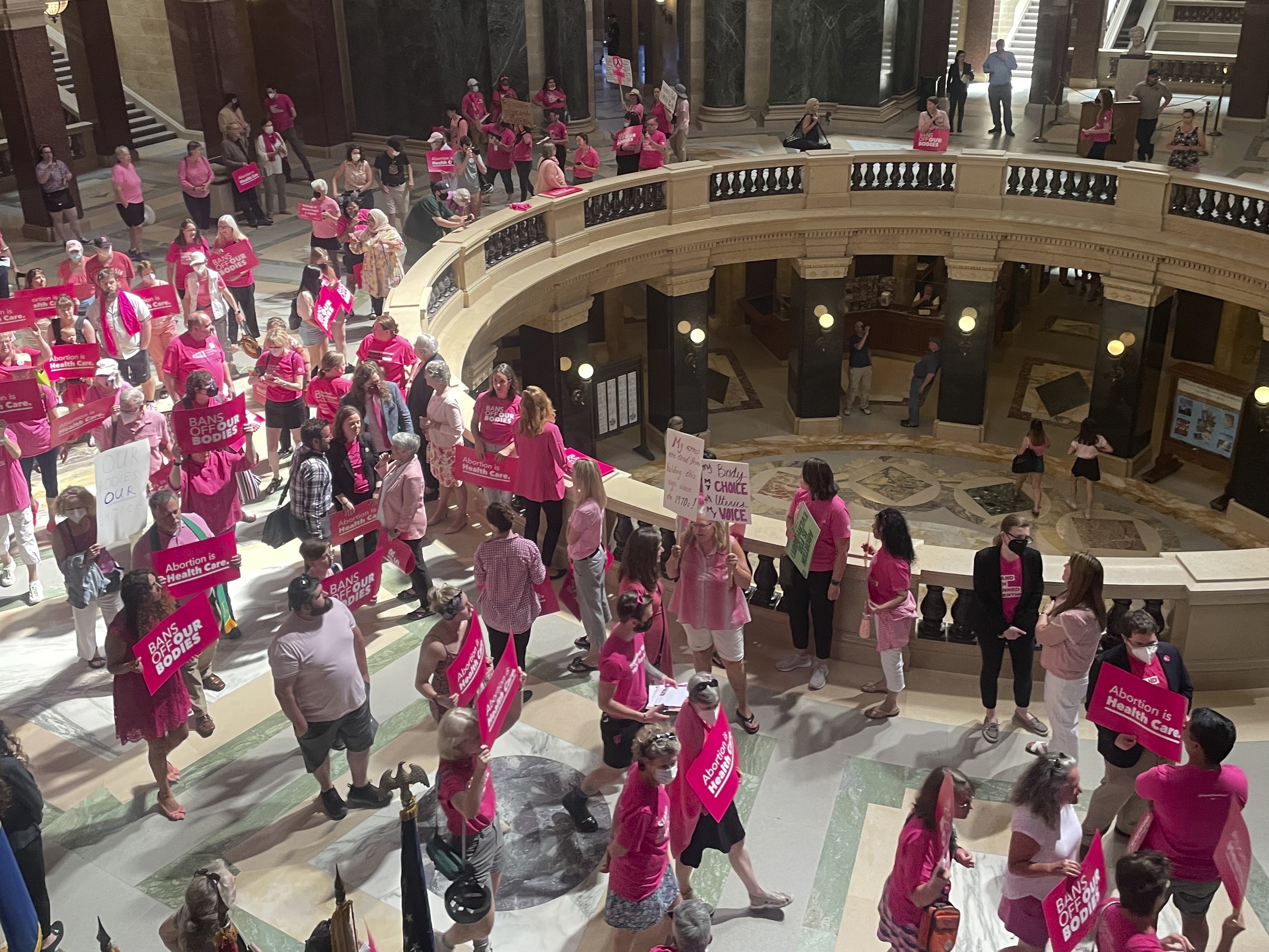 caption: Abortion rights supporters are seen gathering for a "pink out" protest organized by Planned Parenthood in the rotunda of the Wisconsin Capitol, June 22, 2022, in Madison, Wis.
