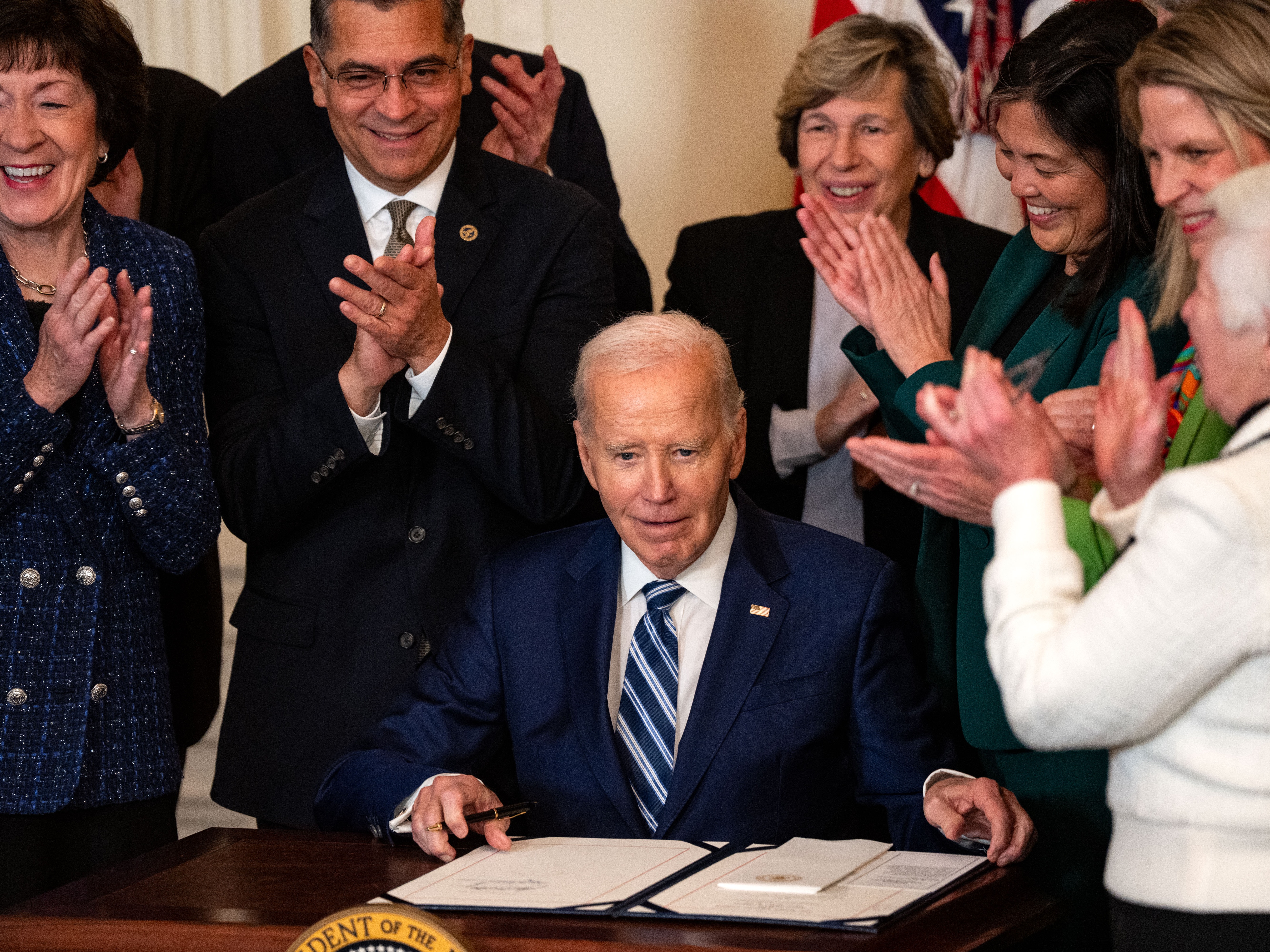 caption: President Biden signs the Social Security Fairness Act during an event in the East Room of the White House on Sunday.