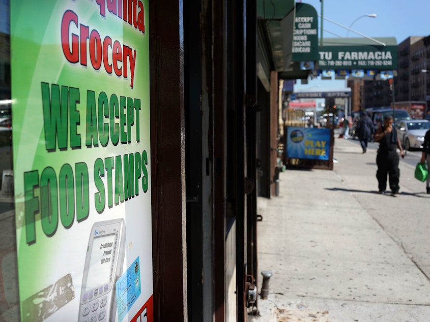 caption: A grocery store in New York City advertises that it accepts food stamps. A Trump administration proposal could result in 3 million people losing their food assistance.