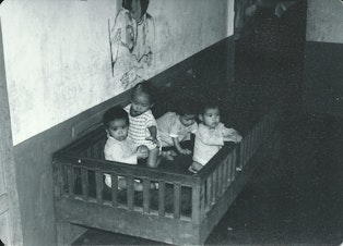 caption: Orphans at the Ghenh Rang Orphanage in South Vietnam before Operation Babylift. Julie Davis, who lives in Minneapolis, believes that's her looking at the camera.