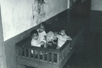 caption: Orphans at the Ghenh Rang Orphanage in South Vietnam before Operation Babylift. Julie Davis, who lives in Minneapolis, believes that's her looking at the camera.