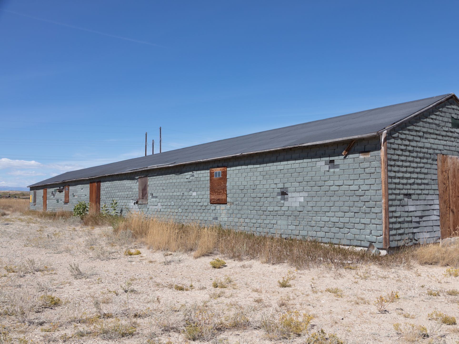 caption: A barracks building at the Heart Mountain Relocation Center, in Park County, Wyo., one of the camps built to confine people of Japanese descent during World War II.