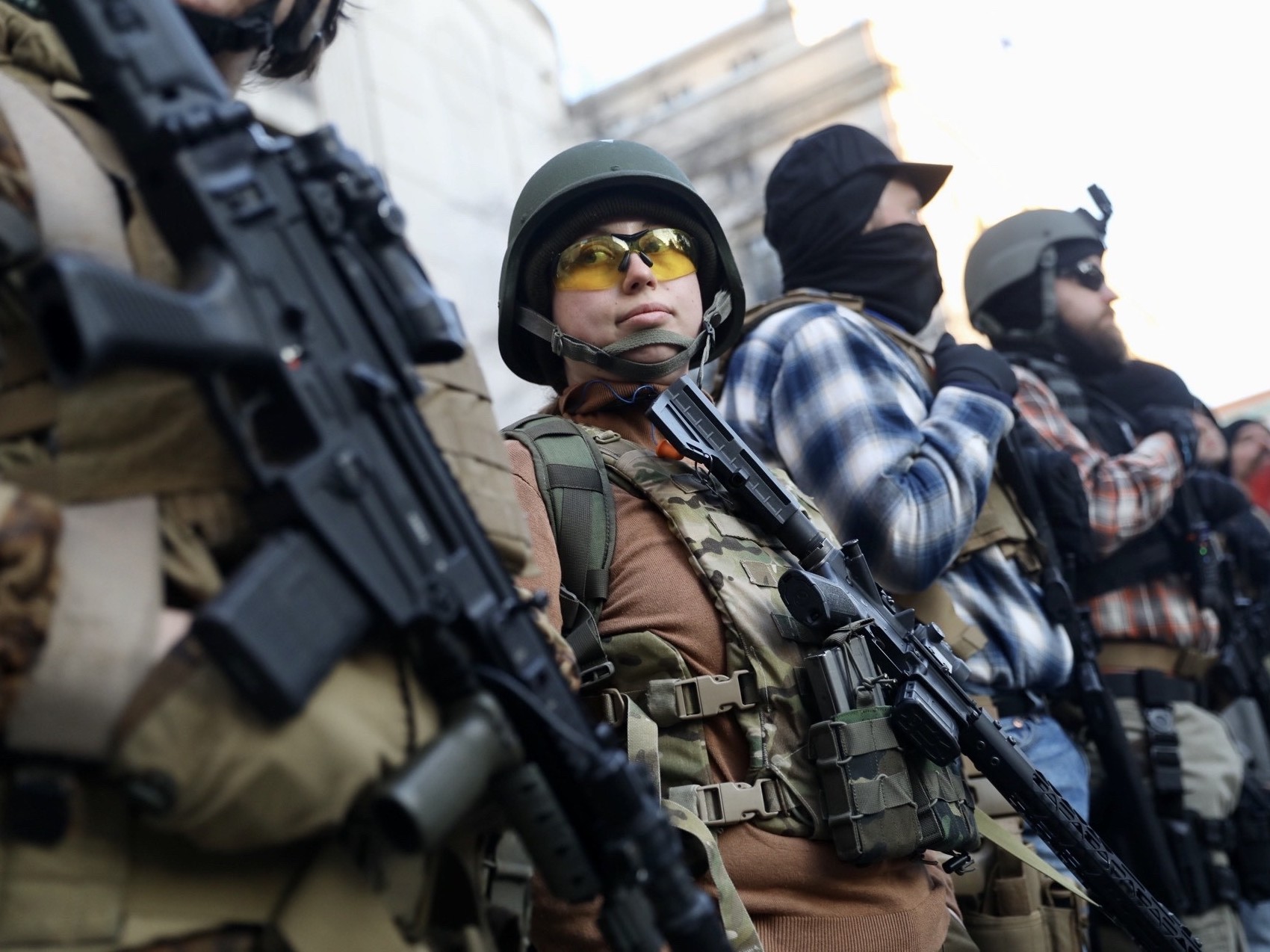 caption: Demonstrators stand outside a security zone in Richmond, Va., on Monday. Thousands of activists and gun enthusiasts converged on the city to urge the state not to pass new gun laws.