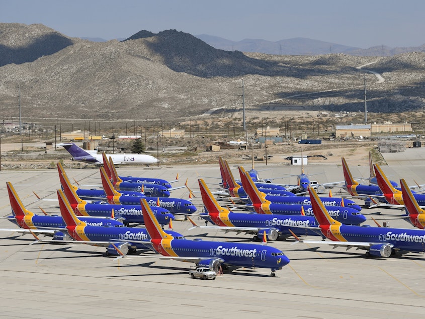 caption: Southwest Airlines Boeing 737 MAX aircraft are parked on the tarmac after being grounded, at the Southern California Logistics Airport in Victorville, California in March.