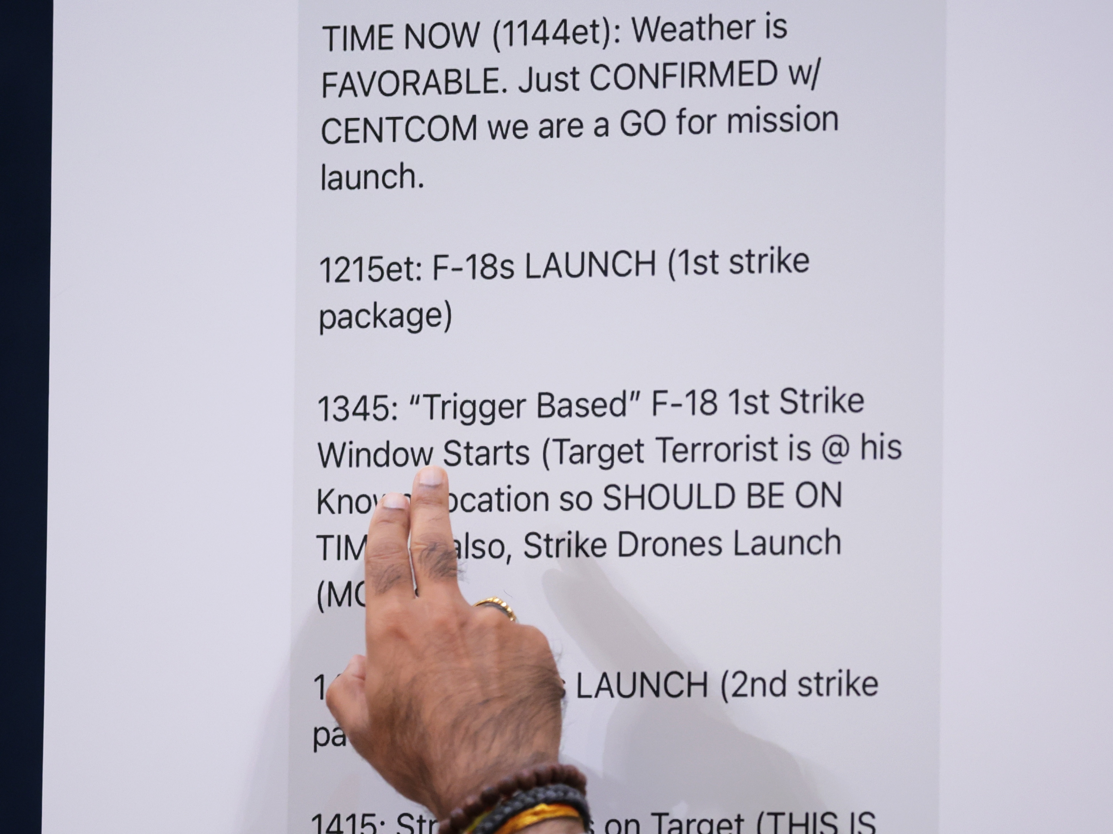 caption: A House lawmaker points to text messages by Defense Secretary Pete Hegseth during a hearing on March 26. The hearing, held by the House Intelligence Committee, addressed Trump administration officials inadvertently including a journalist on a high-level Signal group chat in which plans to bomb Houthi targets in Yemen were discussed.