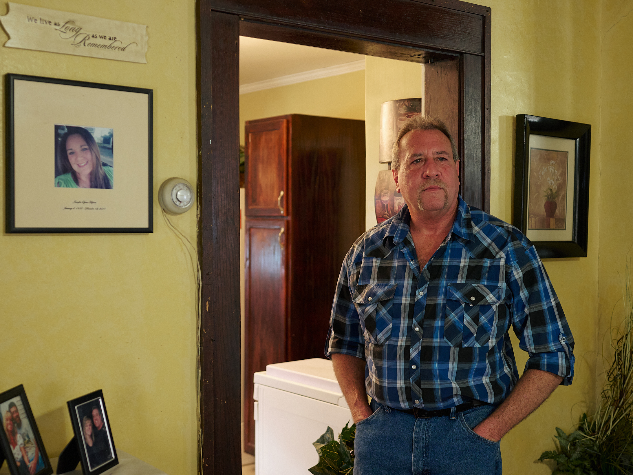 caption: Ernie Haynes stands next to a memorial for his daughter, Jennifer, at his home in Risingsun, Ohio. Following her drug overdose death in 2017, he was charged with abduction after trying to gain custody of his grandchildren. The action sparked a five-year legal battle to clear his name.