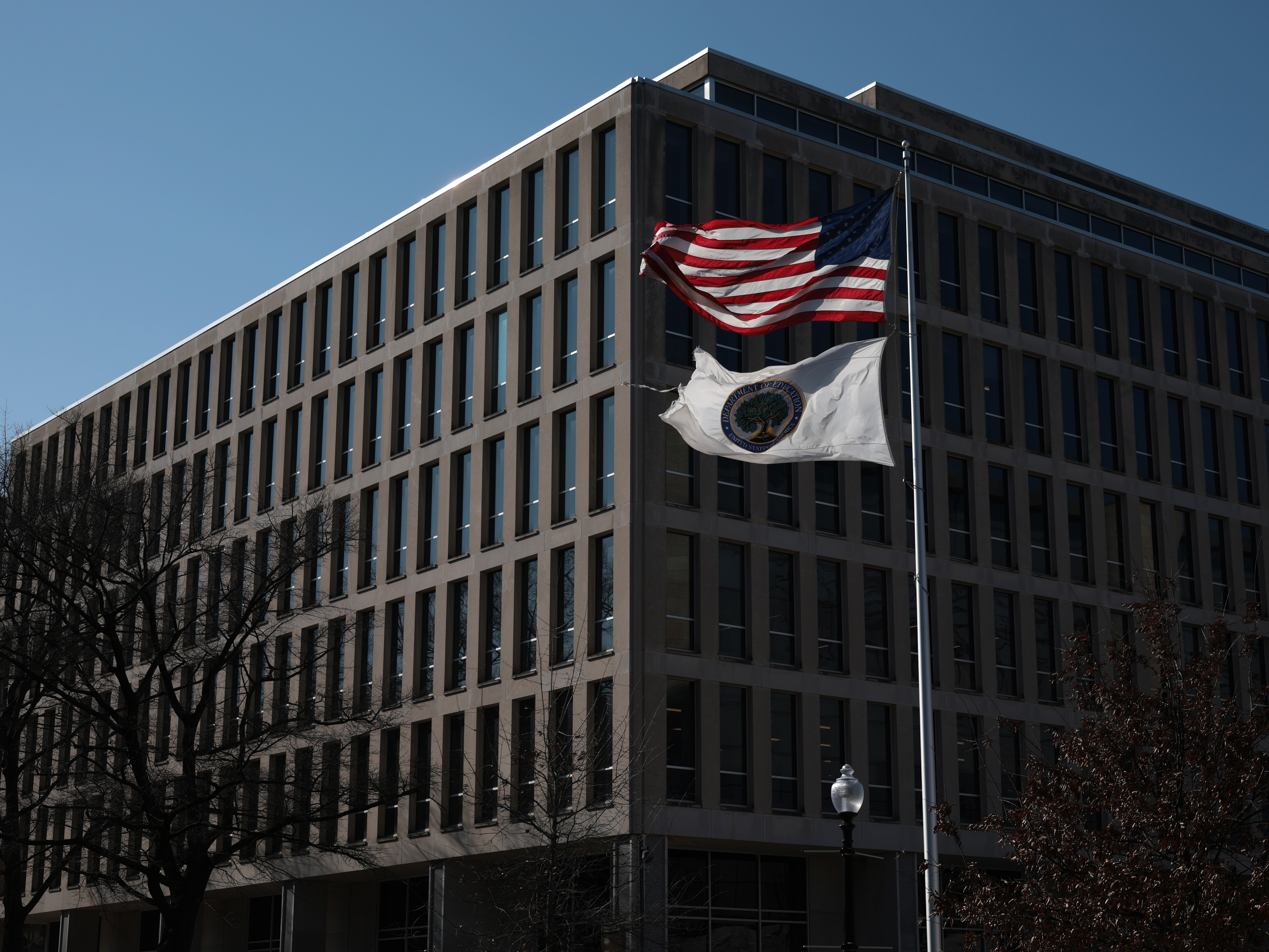 caption: Flags fly outside the U.S. Education Department in Washington, D.C.