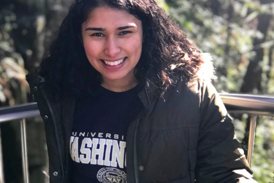 caption: Karishma Vahora poses in a University of Washington sweatshirt in January 2019 when she was a sophomore at UW. Karishma is the first person in her family to go to college.