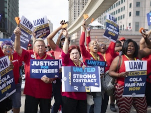 caption: UAW members attend a solidarity rally in Detroit on Sept 15, 2023. The union struck lucrative new deals with each of the Big Three automakers. The UAW now wants to use the momentum to unionize foreign automakers as well as Tesla.