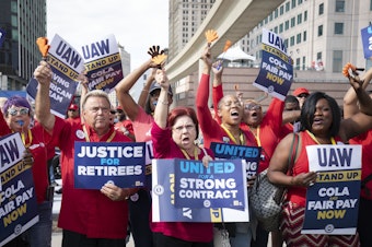 caption: UAW members attend a solidarity rally in Detroit on Sept 15, 2023. The union struck lucrative new deals with each of the Big Three automakers. The UAW now wants to use the momentum to unionize foreign automakers as well as Tesla.