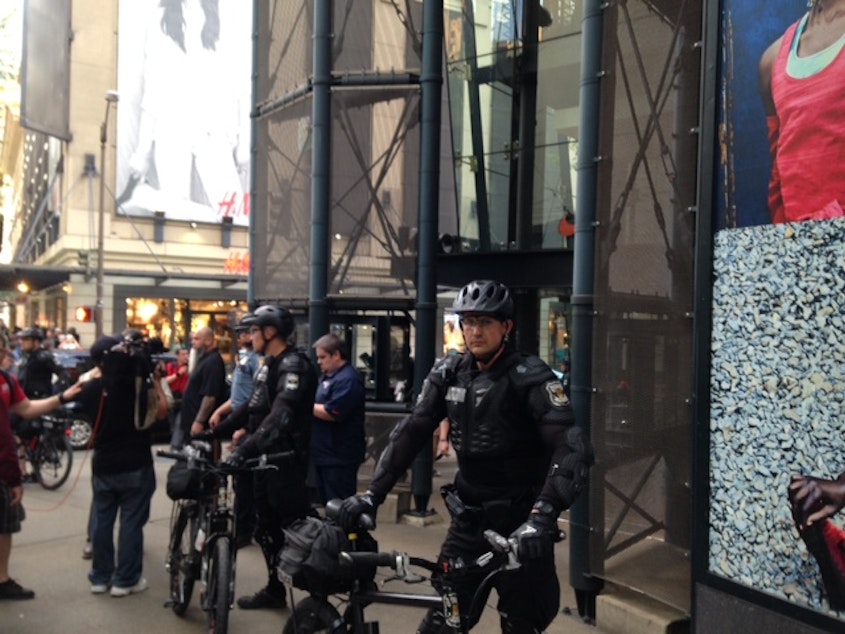 caption: The Seattle Police watch over May Day demonstrators in downtown Seattle.