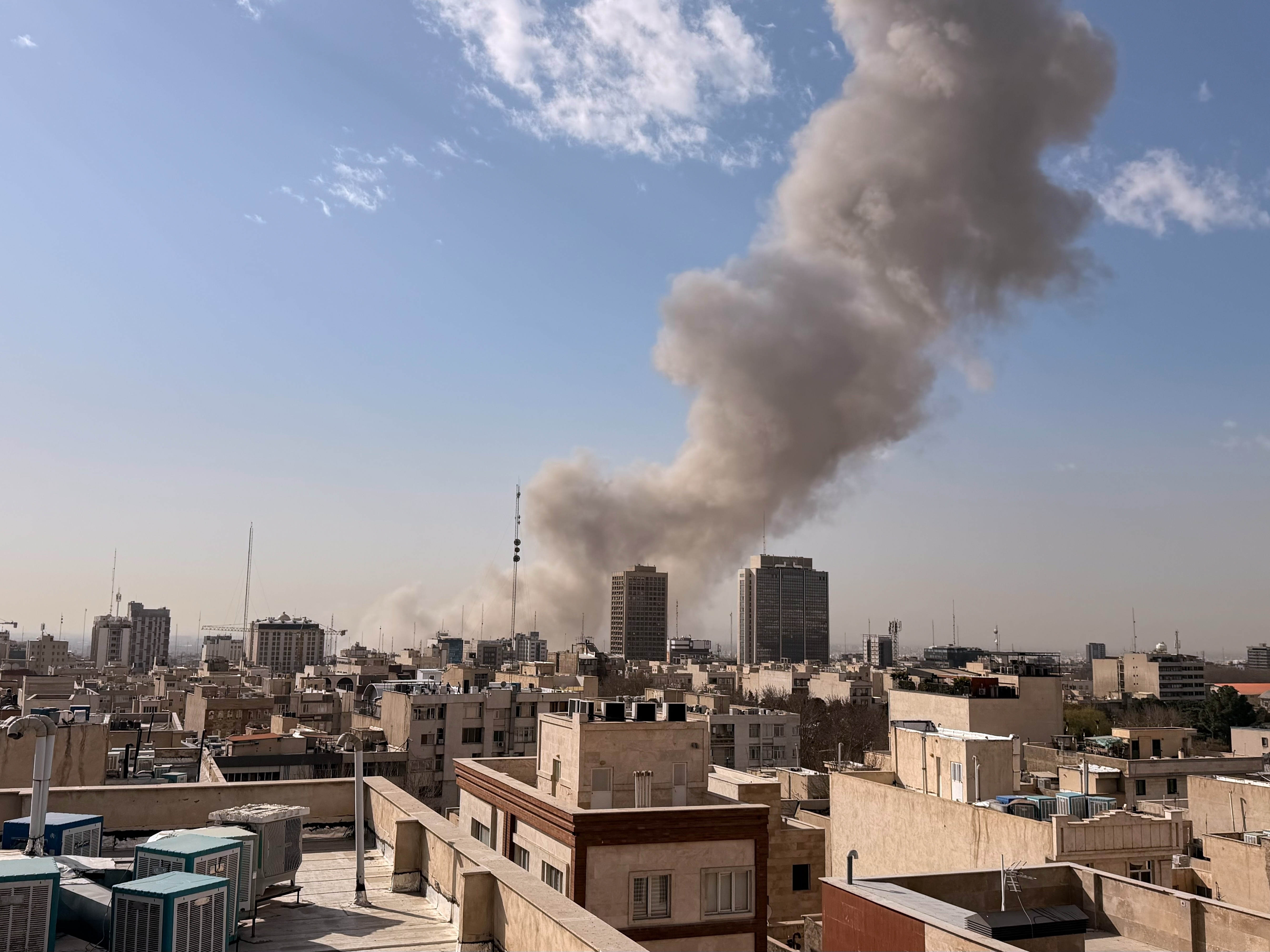 caption: Smoke rises on the skyline after an explosion in Tehran, Iran, Saturday, Feb. 28, 2026.