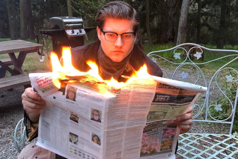 caption: Dyer Oxley reading a newspaper. Everything is fine. 
