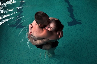 caption: Sgt. Mykhailo (Misha) Varvarych, 28, and his fiance, Iryna (Ira) Botvynska, 19, take part in a therapeutic swimming activity at Moldova pool in Truskavets, Ukraine.