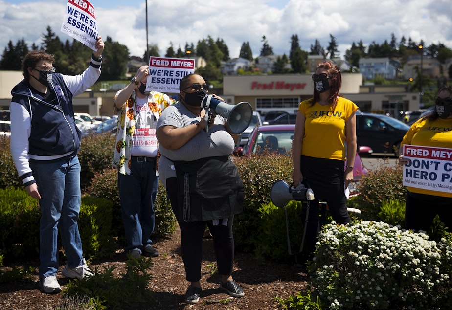 caption: Maria Rouse-Williams speaks to a crowd on Friday, May 15, 2020, at the Don't Cut Hero Pay rally outside of Fred Meyer along 1st Avenue South in Seattle. "I'm here not just for myself but for everybody in my store who needs representation -- who needs to be heard," said Rouse-Williams. "Nobody hears the essential workers." 