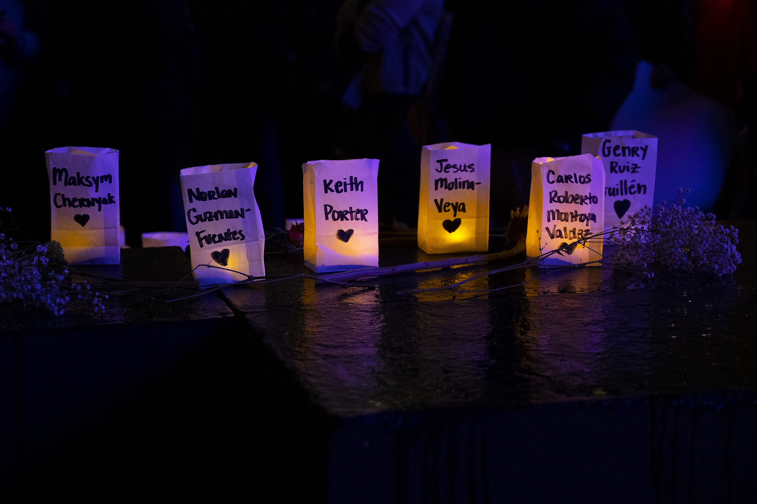 caption: Names of those killed by ICE agents, including Keith Porter who was shot and killed by an off duty ICE agent in Los Angeles on New Years Eve, are shown during a vigil for Renee Nicole Good on Thursday, January 8, 2026, at Pier 58 in Seattle. 
