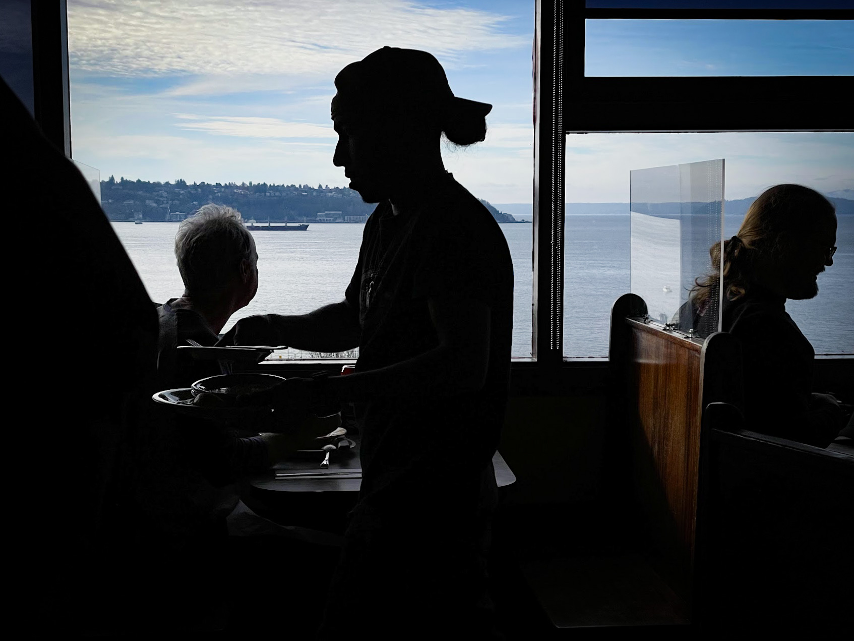 caption: Costumers enjoy a stunning view at a restaurant at Pike Place Market in downtown Seattle.