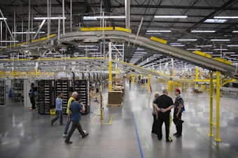 caption: The interior of an Amazon fulfillment center is shown on Friday, November 3, 2017, in Kent.