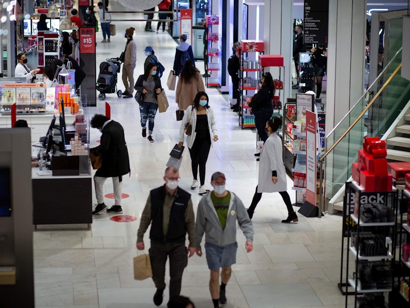 caption: Shoppers walk through Macy's in New York on Black Friday, Nov. 27.