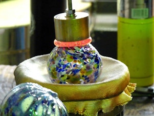 caption: Monkeyshines are glass floats, a traditional style of glass orb. These include an emblem for the lunar new year sign.