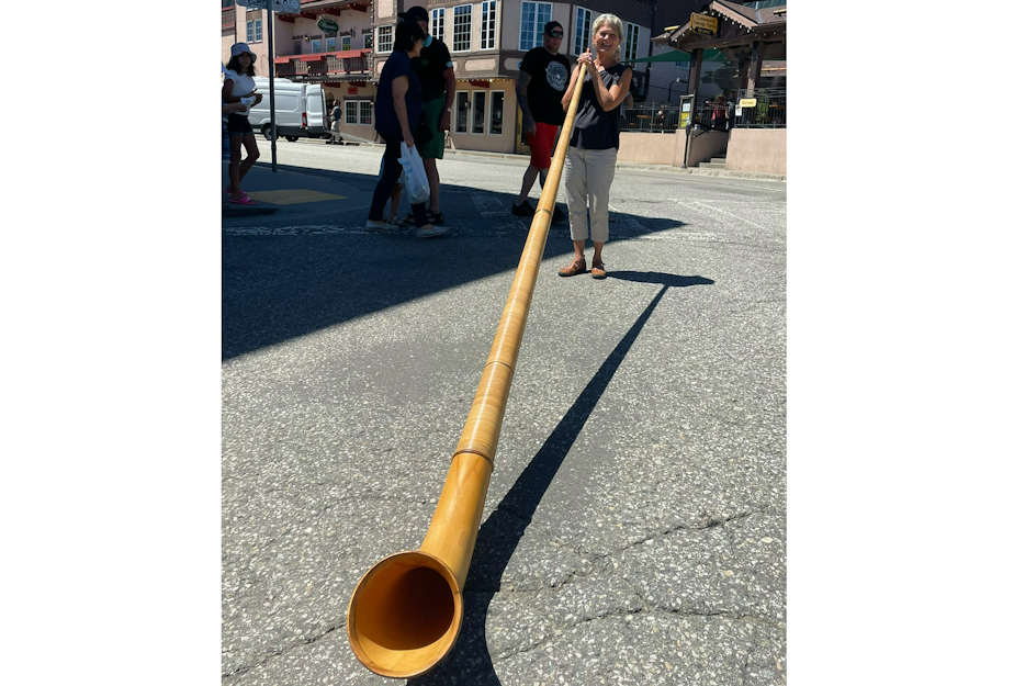 caption: Janet Malo plays her alphorn in downtown Leavenworth.