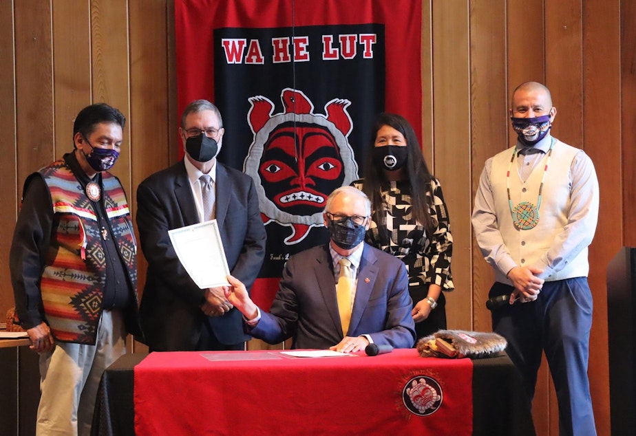 caption: Washington Gov. Jay Inslee signed the Billy Frank Jr. statue bill into law at Wa He Lut Indian School on Wednesday. Looking on, from left, were Nisqually Tribal Chairman Ken Choke, Lt. Gov. Denny Heck, state Rep. Debra Lekanoff and tribal councilman Willie Frank III.