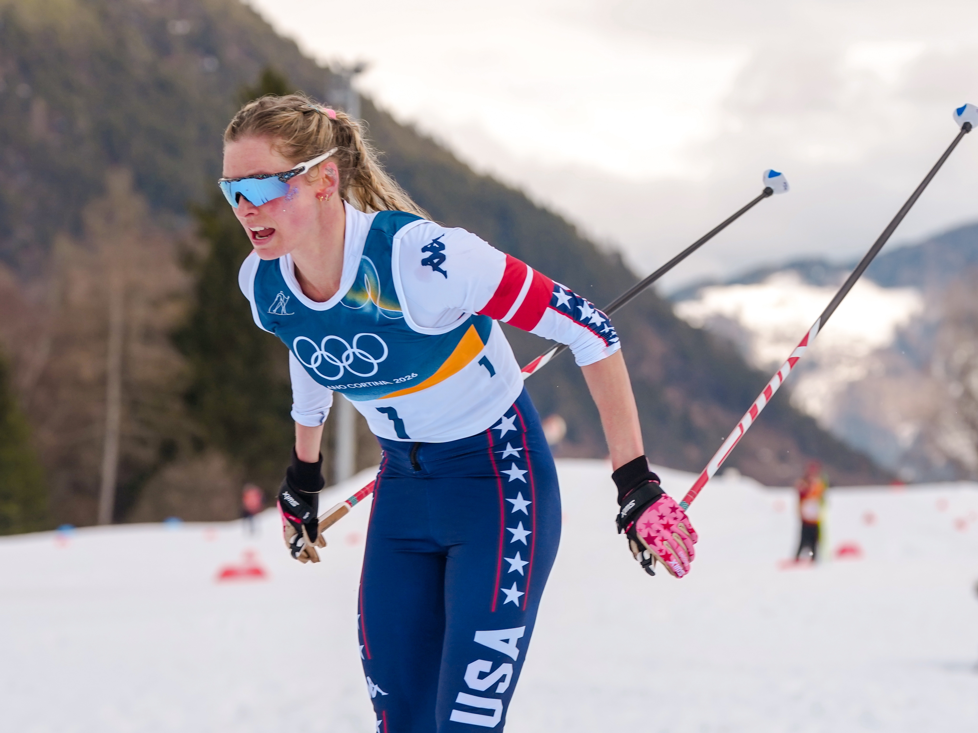 caption: American cross-country skier Jessie Diggins is among the athletes quarantining themselves away from spouses during the 2026 Milan Cortina Winter Olympics