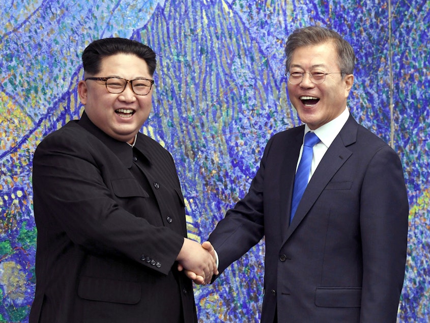 caption: North Korean leader Kim Jong Un (left) poses with South Korean President Moon Jae-in in April at the border village of Panmunjom.