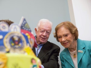 caption: Former first lady Rosalynn Carter looks at a birthday cake with her husband, former President Jimmy Carter, during his 90th birthday celebration held at Georgia Southwestern University, Oct. 4, 2014, in Americus, Ga.