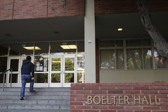caption: A student enters Boelter Hall at University of California, Los Angeles on Thursday. Hundreds of students and staff at two Los Angeles universities, including UCLA, have been placed under quarantine because they may have been exposed to measles and either have not been vaccinated or cannot verify that they are immune, officials said Thursday.