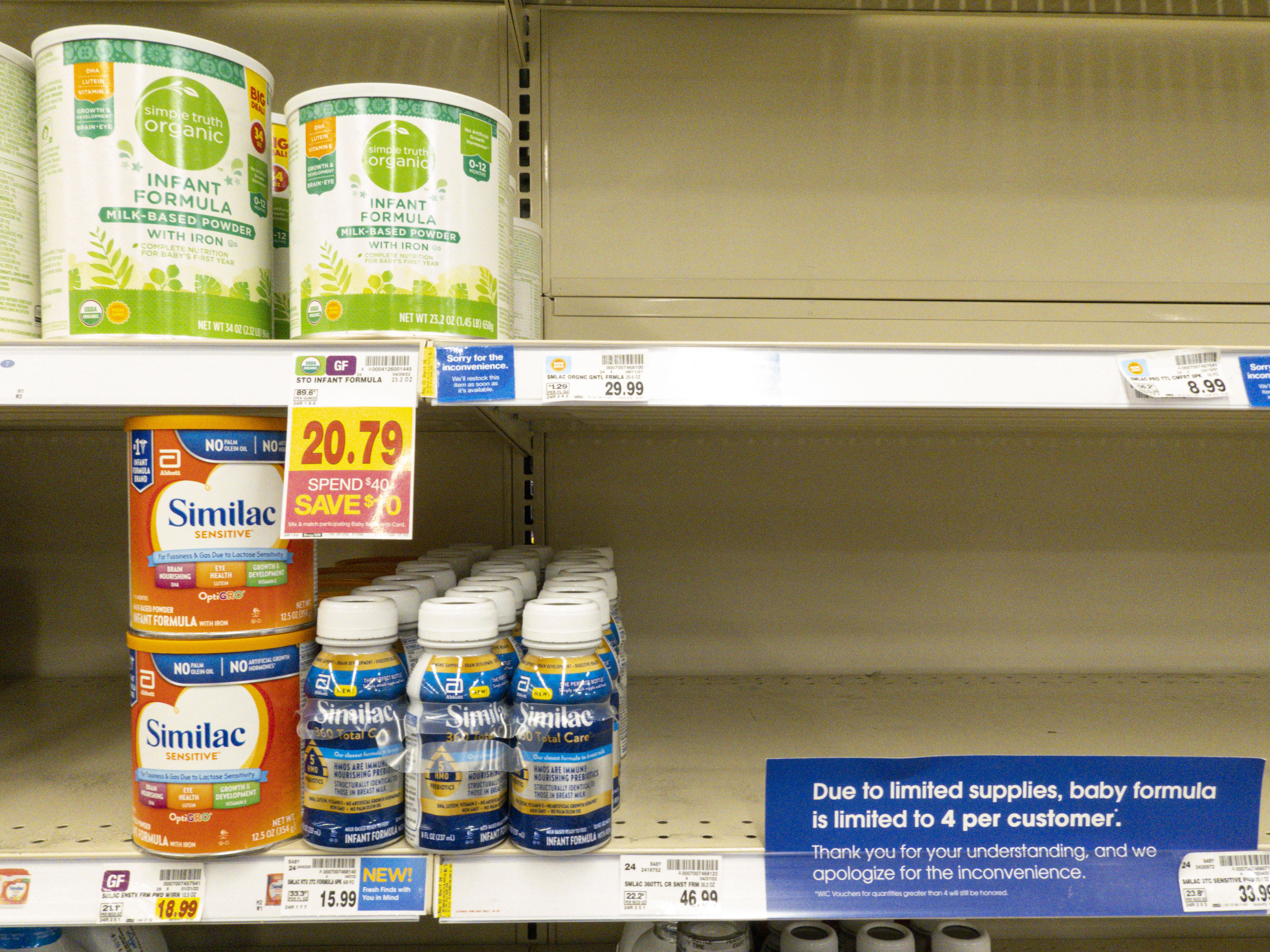 caption: Baby formula is displayed on the shelves of a grocery store with a sign limiting purchases in Indianapolis on Tuesday.