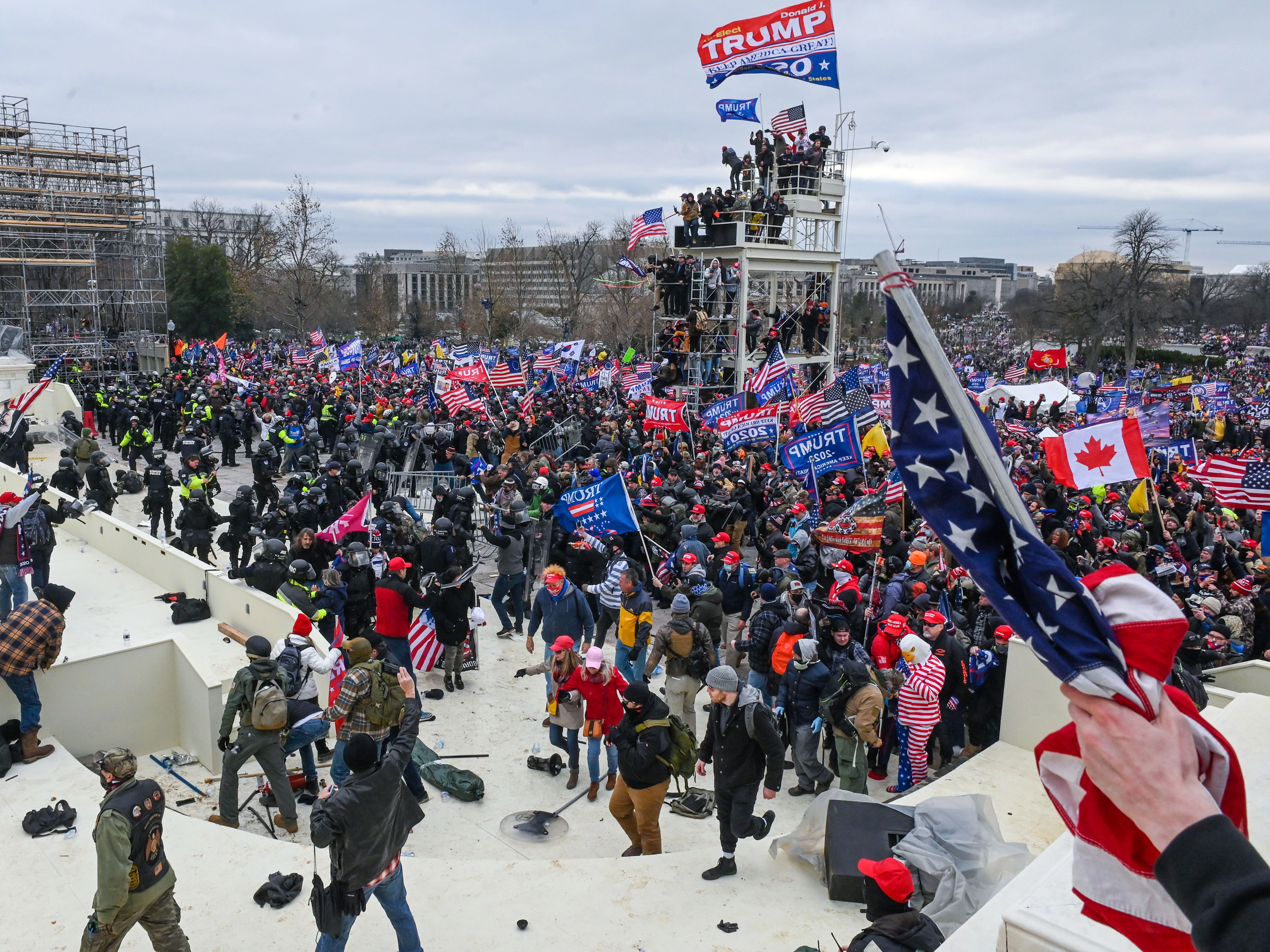 caption: Pro-Trump extremists clash with police and security forces as they invade the Inauguration Day platform on Wednesday. Security forces were quickly overrun as the mob reached the Capitol.