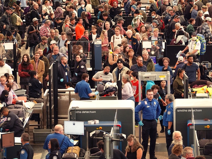 caption: A crowded security checkpoint at Denver International Airport on Nov. 22, days before Thanksgiving.