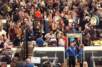 caption: A crowded security checkpoint at Denver International Airport on Nov. 22, days before Thanksgiving.