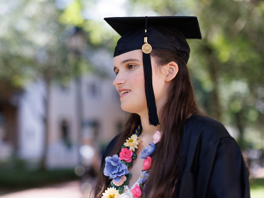 caption: "God gave you a voice. Use it," Elizabeth Bonker told her fellow graduates. "And no, the irony of a nonspeaking autistic encouraging you to use your voice is not lost on me."