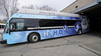 caption: Kevin Baker, a maintenance technician, drives a hydrogen fuel cell bus out of the terminal, Tuesday, March 16, 2021, in Canton, Ohio.