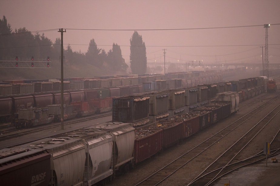 caption: Air quality in Seattle turned hazardous according to the state Department of Ecology, as wildfire smoke from California and Oregon settled in the area Saturday, September 12, 2020. Here, Balmer Yard is shown at sunrise.