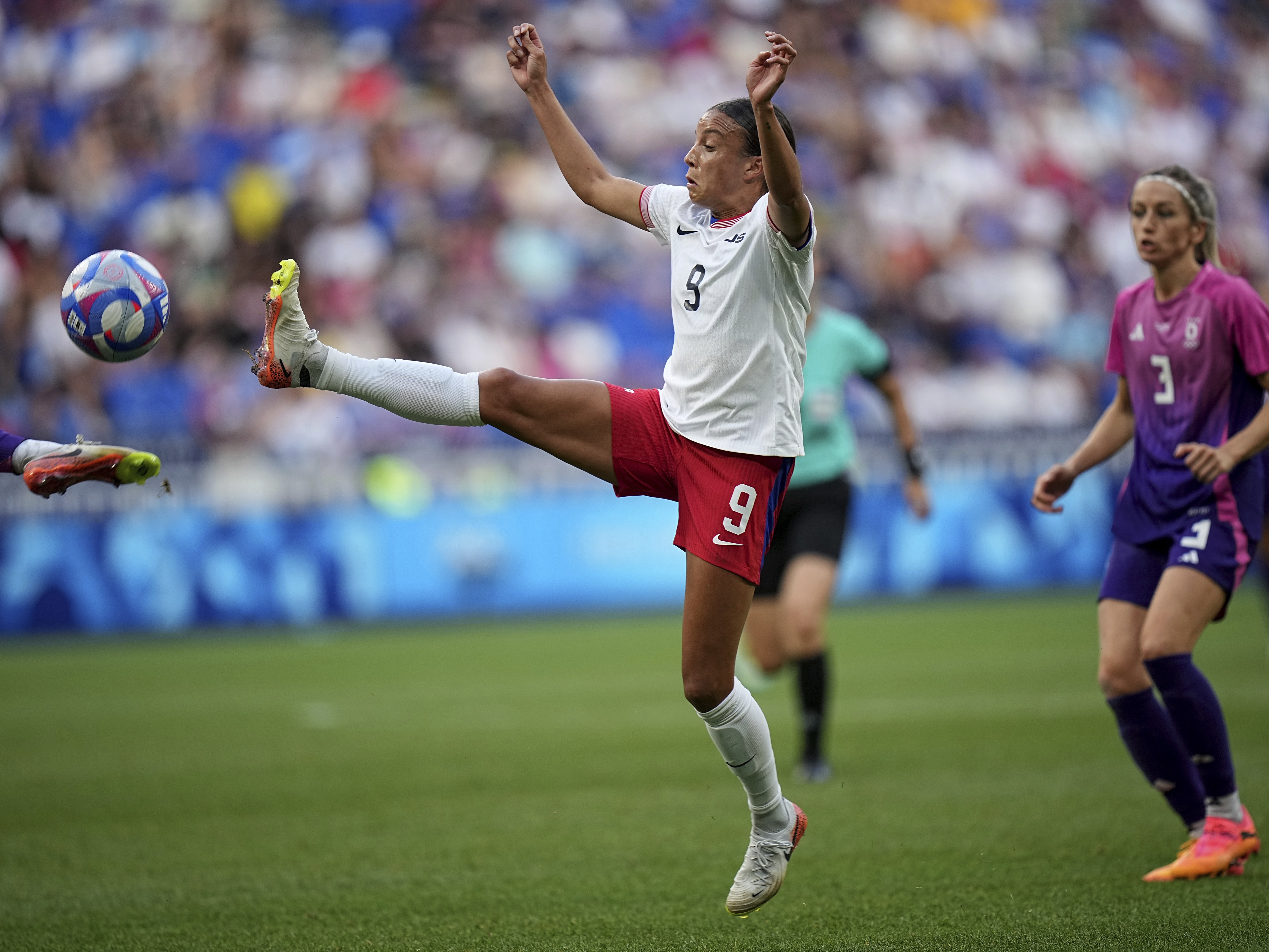 caption: The U.S. women's soccer team defeated Germany 1-0 to advance to its first gold medal match at the Olympics since 2012. The U.S. team's Mallory Swanson fights for the ball during the semifinal match on Tuesday at Lyon Stadium in Decines, France.