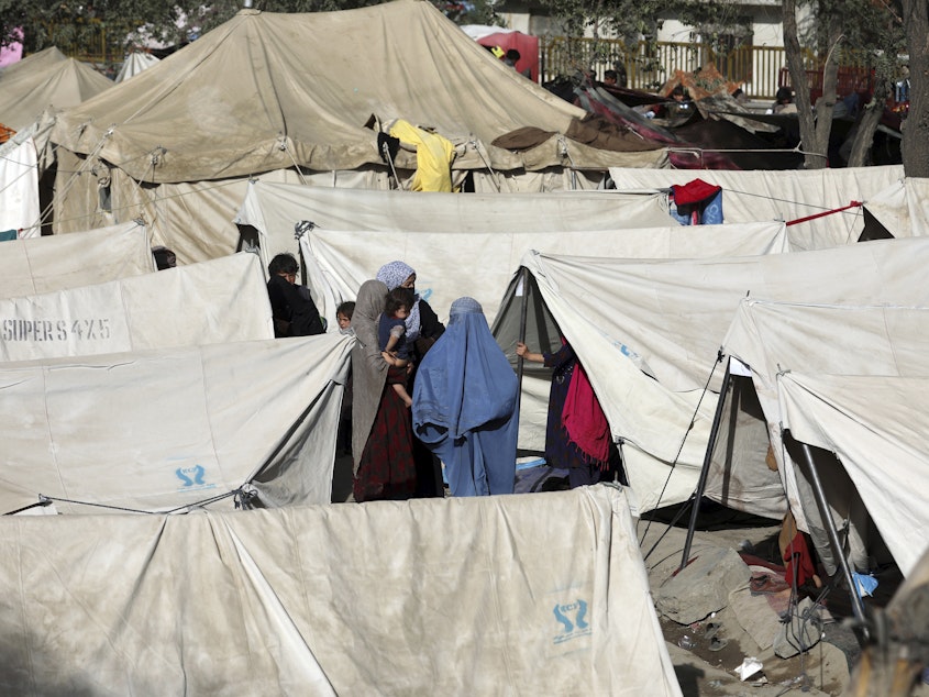caption: Internally displaced Afghans from northern provinces, who fled their home due to fighting between the Taliban and Afghan security personnel, take refuge in a public park Kabul, Afghanistan, on Friday.