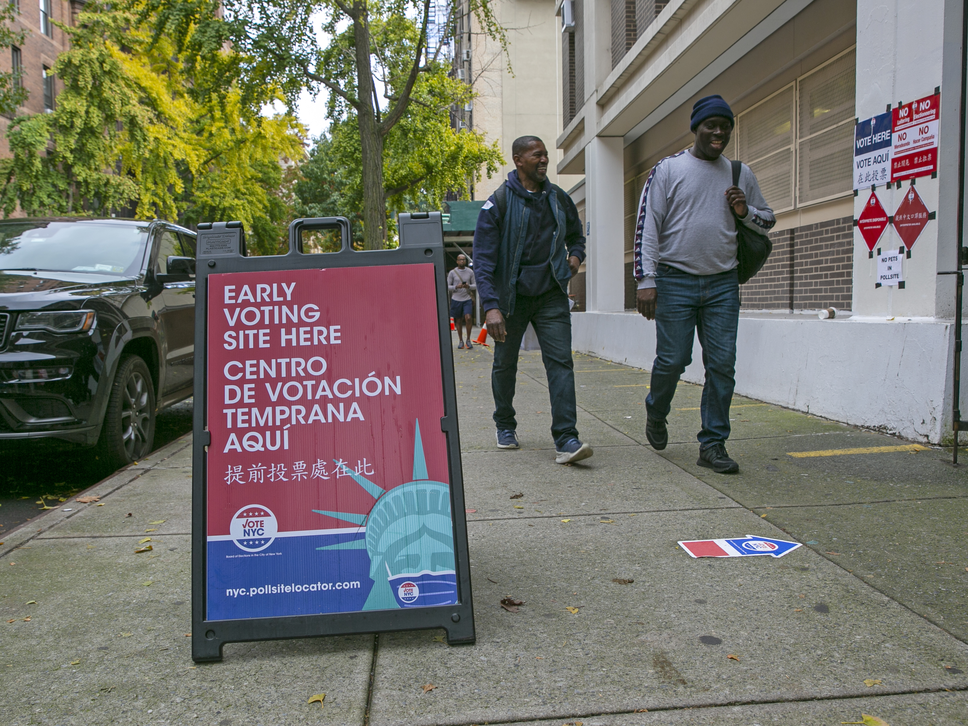 caption: Signs indicate the location of an early voting polling site at Frank McCourt High School on the Upper West Side of Manhattan in New York City on Tuesday, November 1, 2022.