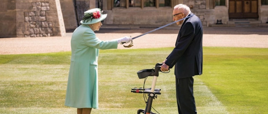caption: In July, Queen Elizabeth conferred knighthood on World War II veteran Capt. Tom Moore at Windsor Castle.