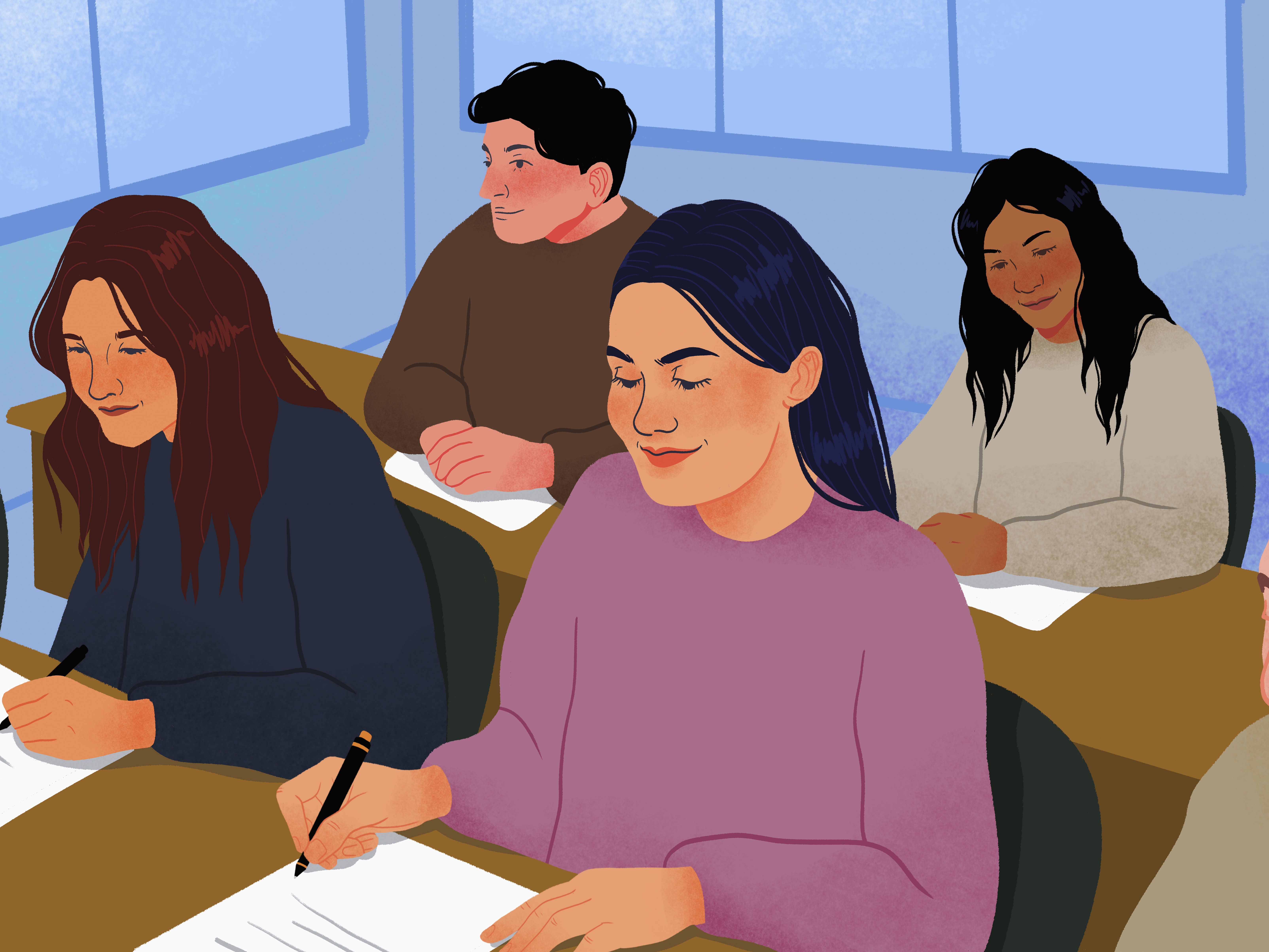 College students taking exam in classroom