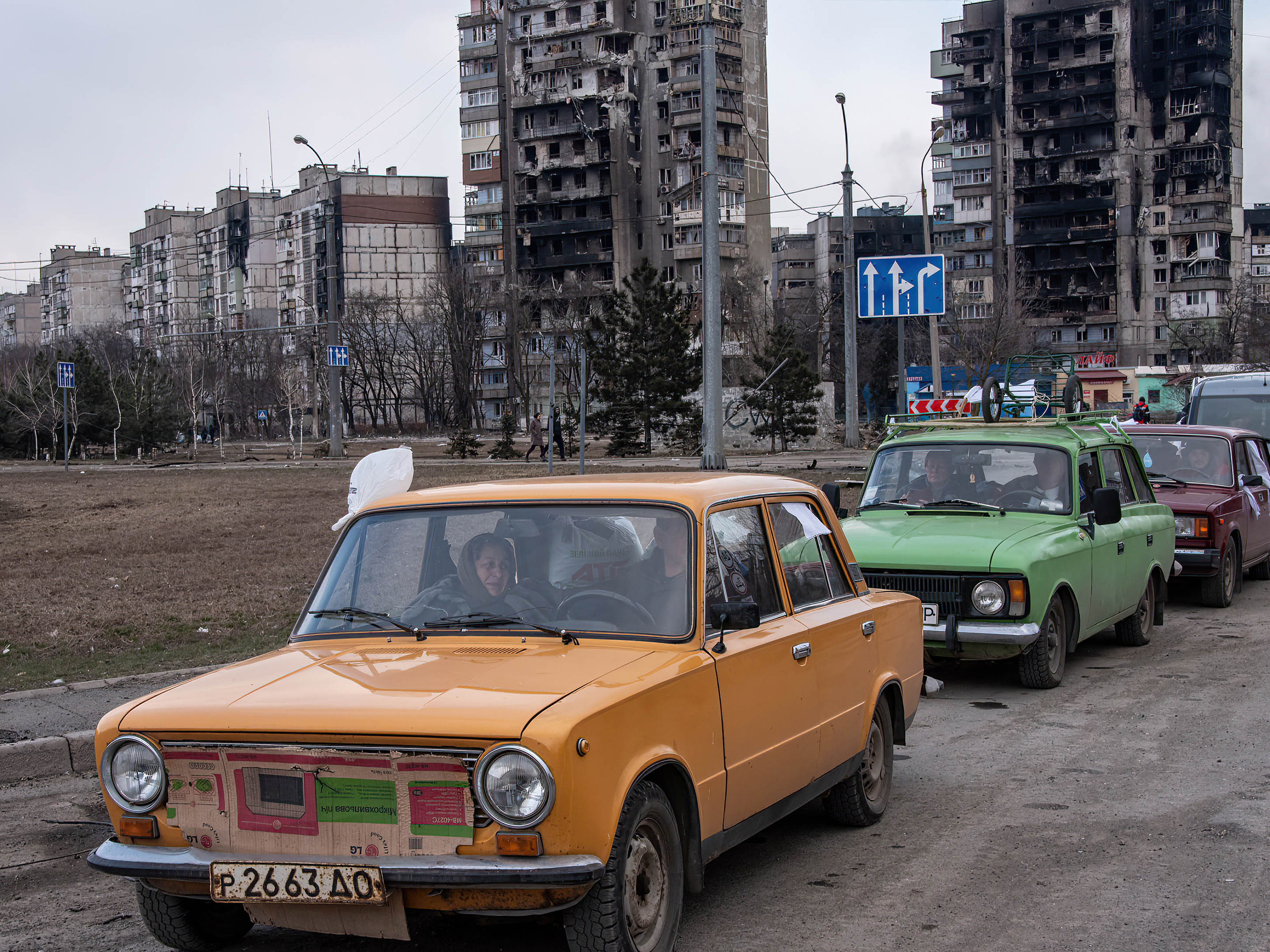 caption: Cars wait in a long line to leave Mariupol, on March 17. The city, on Ukraine's southeastern coast, has been heavily damaged by Russian bombardment.
