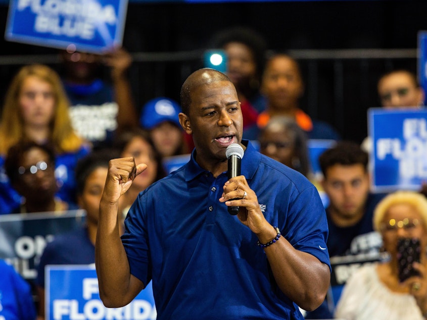 caption: Former Florida gubernatorial candidate Andrew Gillum addresses the audience during an event in 2019 in Miami Gardens. Gillum, a Democrat, was indicted Wednesday by a federal grand jury alleging he sought campaign donations and funneled a portion of them back to him through third parties.