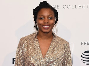 caption: Director and screenwriter Nia DaCosta (shown here in 2018) has made history with the debut of her horror film <em>Candyman.</em>