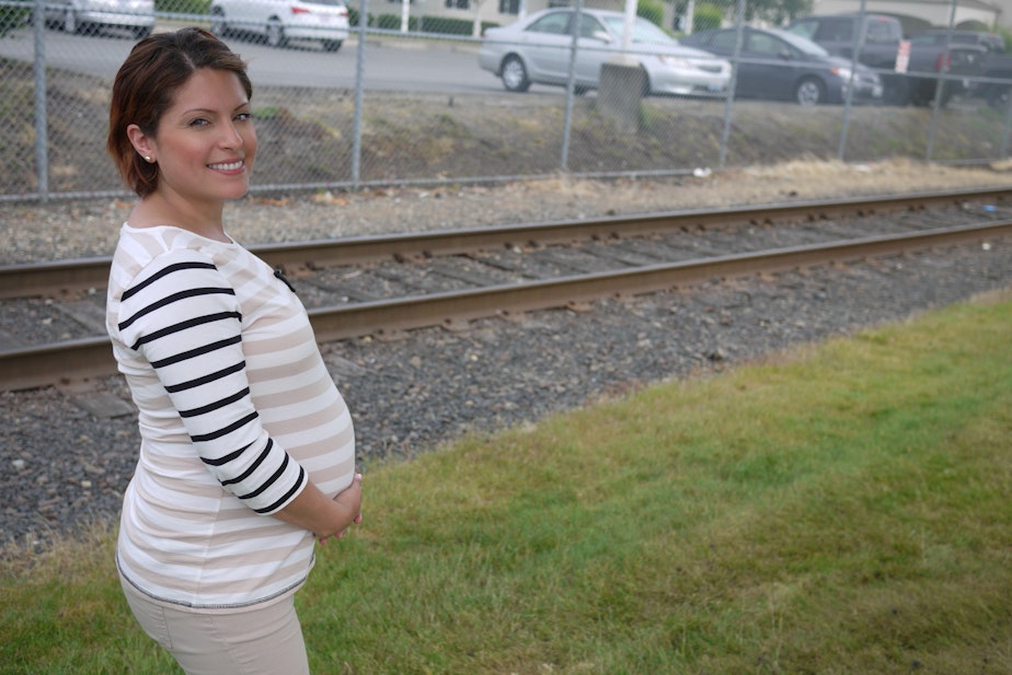 caption: An expectant mother outside the Northwest Detention Center in Tacoma, where an immigration judge just ordered the baby's father to return to Mexico.