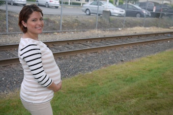 caption: An expectant mother outside the Northwest Detention Center in Tacoma, where an immigration judge just ordered the baby's father to return to Mexico.