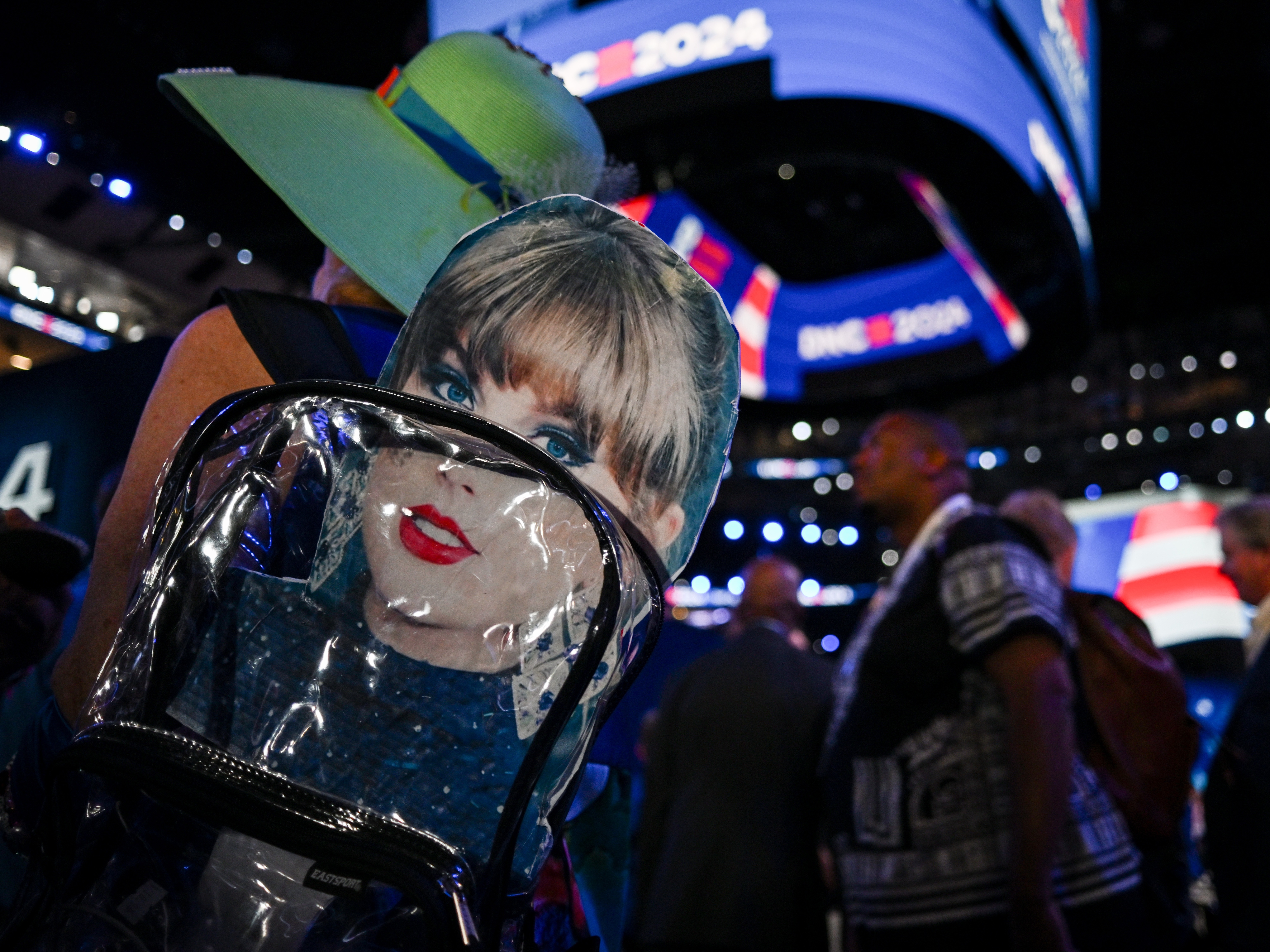 caption: An attendee wears a backpack with a Taylor Swift sign during the third day of the Democratic National Convention in Chicago. Swifties for Kamala, a grassroots group not affiliated either with Swift or the Harris campaign, raised more than $140,000 for the Democratic presidential nominee after a call Tuesday night.