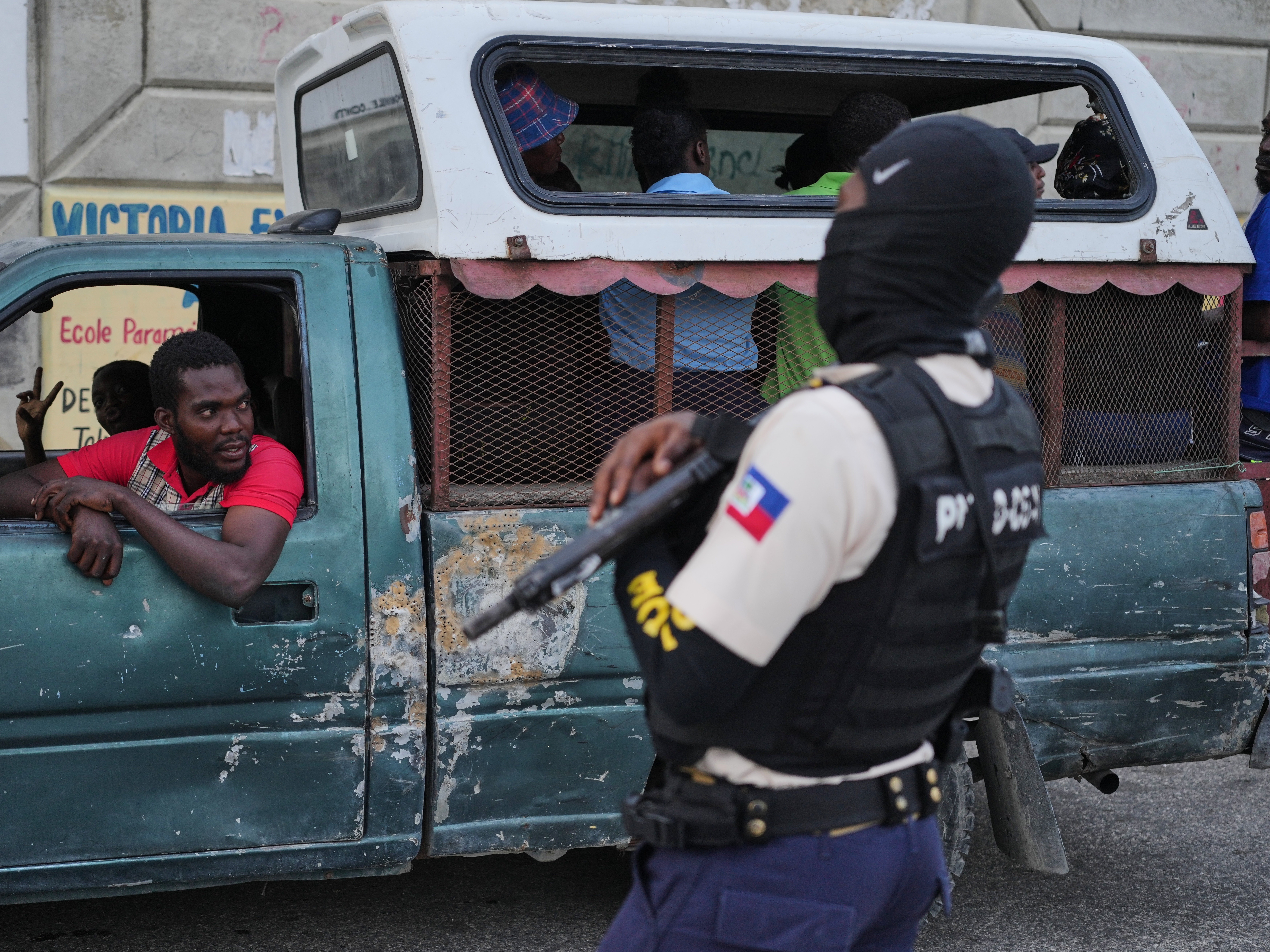 caption: A police officer stands guard in Port-au-Prince, Haiti, Tuesday, March 3, 2026.